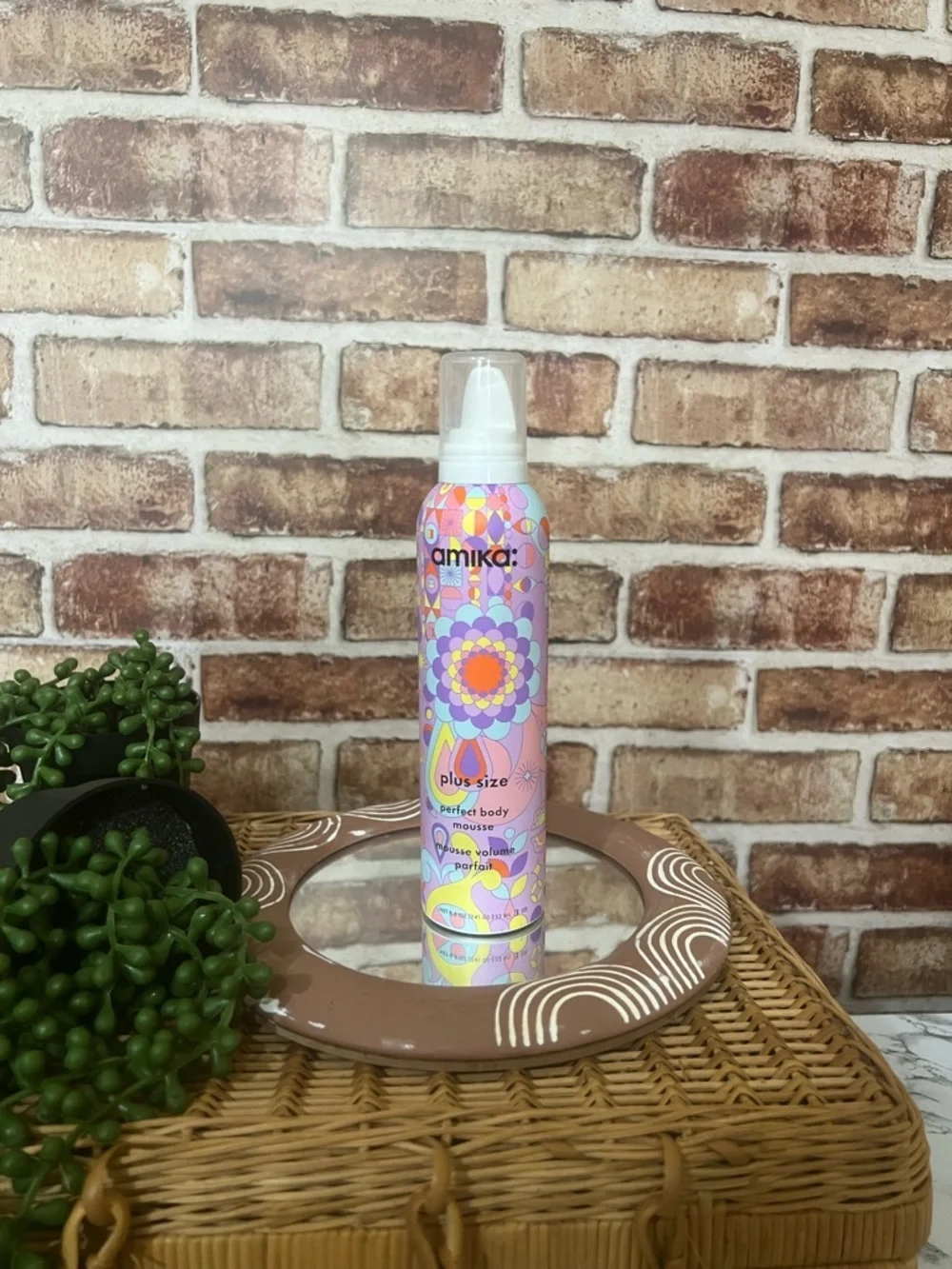 amika body mousse in pink, purple & yellow patterned bottle